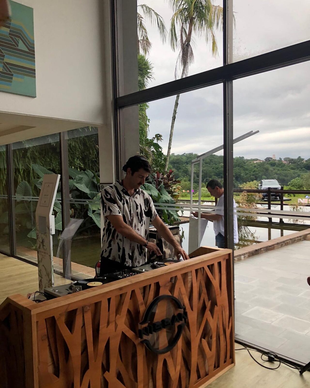 Pedro Etcheverry musicalizando con vinilos en cabina de madera con logo de Nissan durante el lanzamiento de la Frontier en el Hotel Meliá Iguazú, Misiones